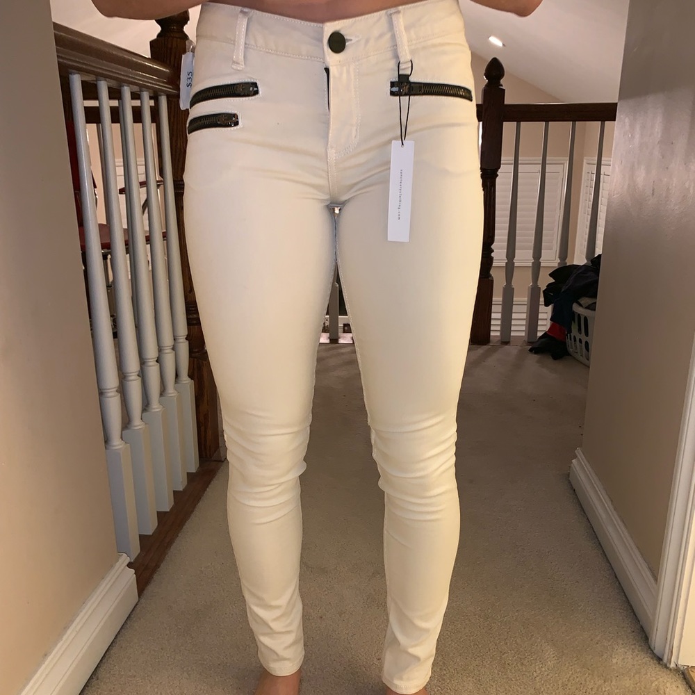 Creme pants with black zippers